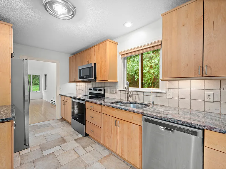 Kitchen with stainless steel appliances, cabinet underlighting, plenty of counter and cabinet space