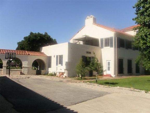 Showing back and side of the Gorgeous house with long Breezeway. Notice one of the three balconies o