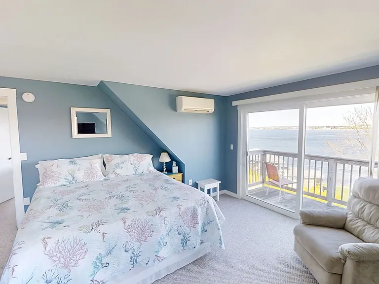 Primary bedroom with king size bed, ensuite full bath with tub/shower combo and ocean view balcony