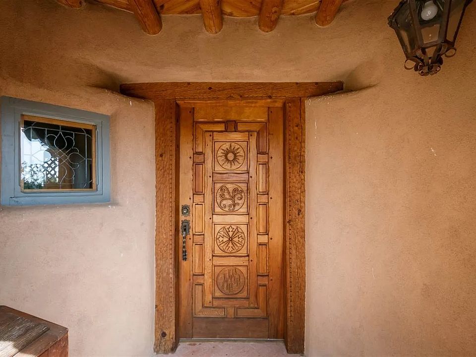 Hand carved front entry with numerous hand made lead glass windows throughout the home