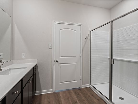 The master bathroom has a glass, walk-in shower.