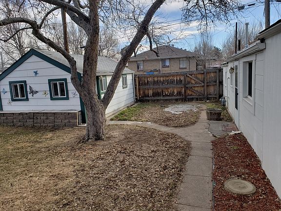 The yard space. Structure on left is the shed/workshop, the carriage house is on the right