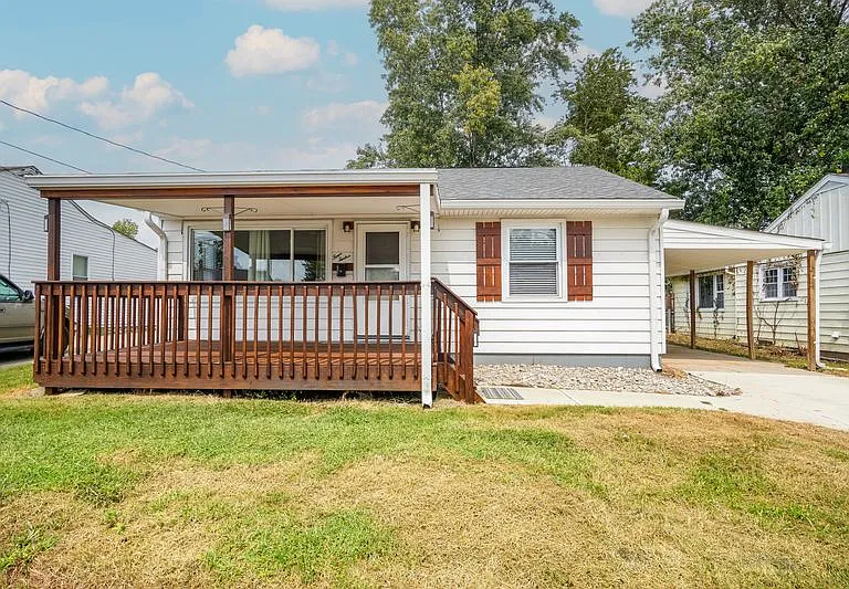 Front of the home. Covered front porch and carport