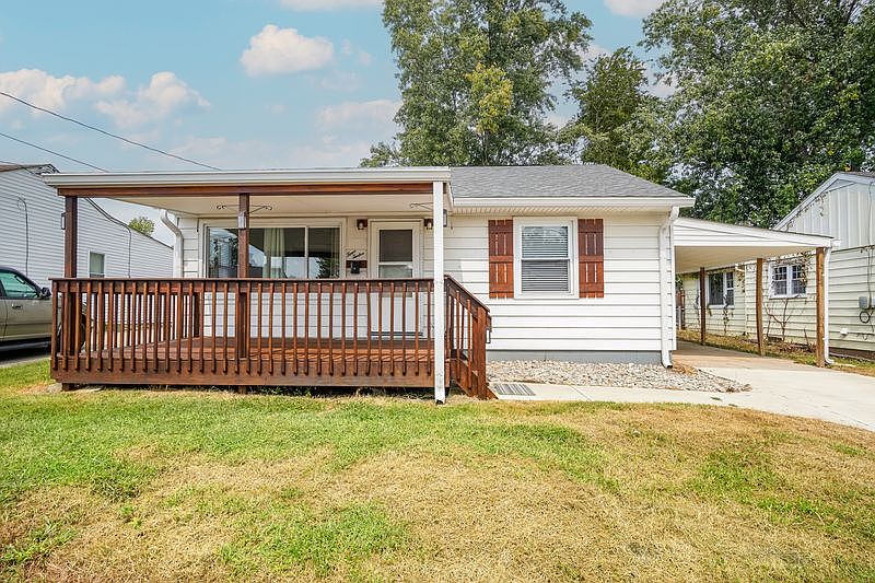 Front of the home. Covered front porch and carport
