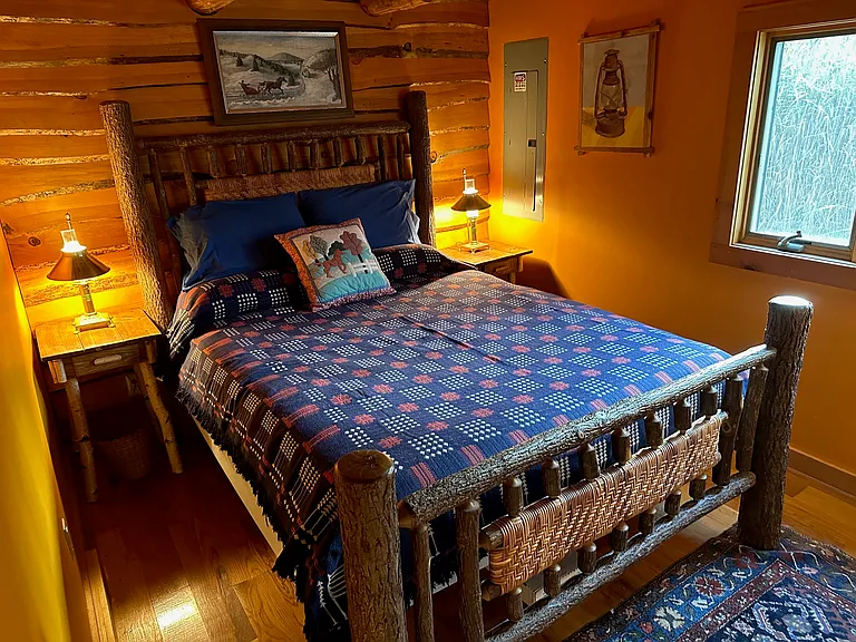 Master Bedroom at dusk with twig side tables and vintage brass lamps.
