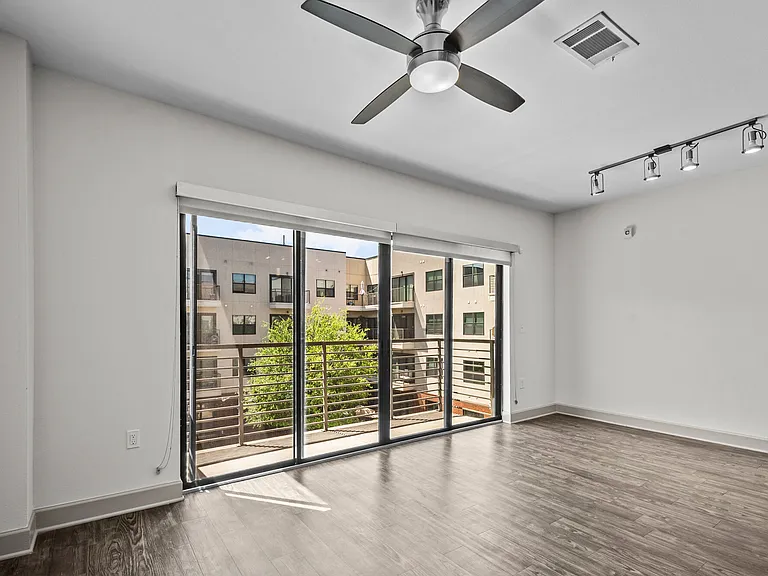 Bright living space with private balcony views