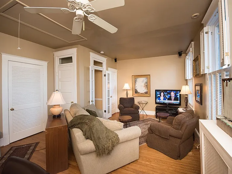 Den with queen sleeper sofa, TV, desk.