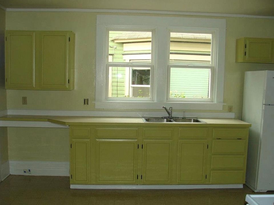 Kitchen opens to private back porch, which leads to basement laundry room