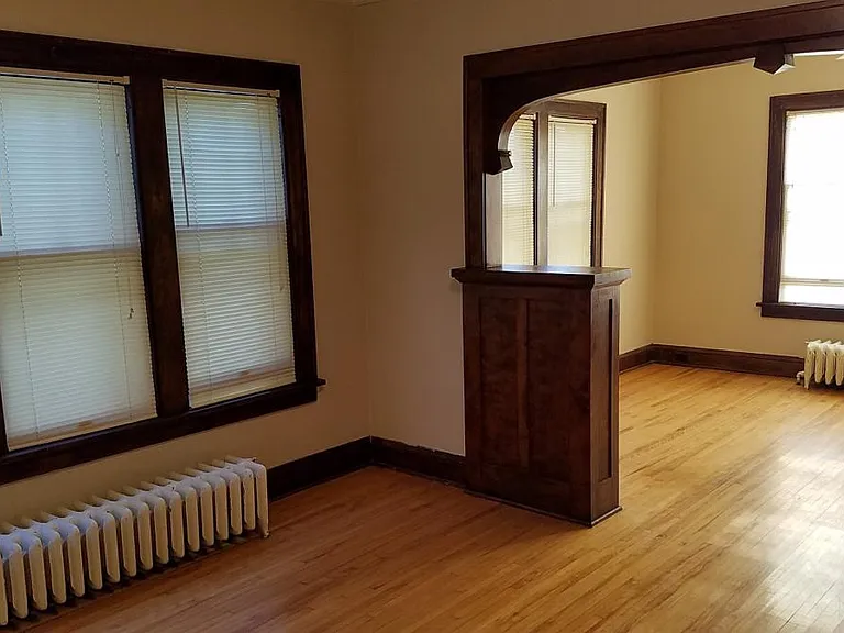 View from kitchen doorway. Eight windows between the LR & DR. Hardwood floors.