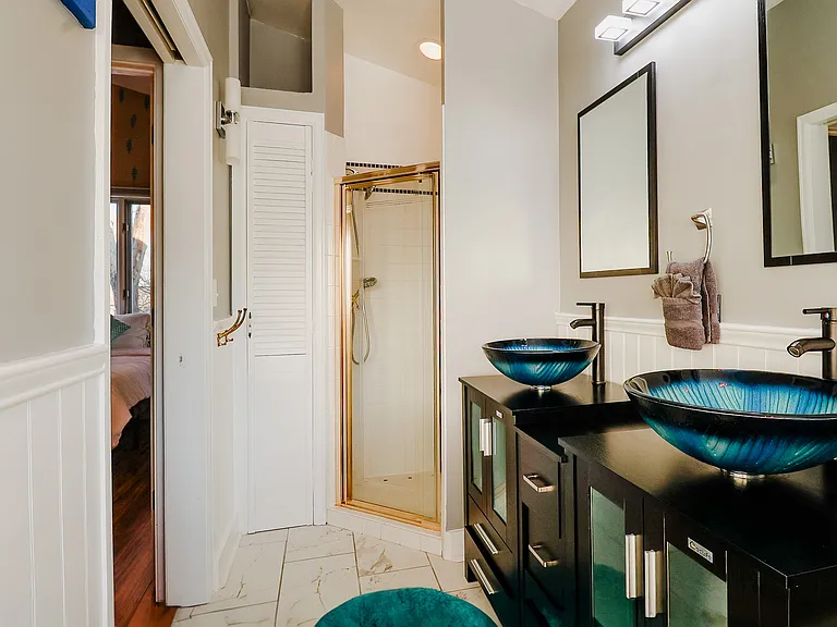 A bathroom designed with a chic combination of blue, black, and white tones, creating a sleek and contemporary space for relaxation and rejuvenation.