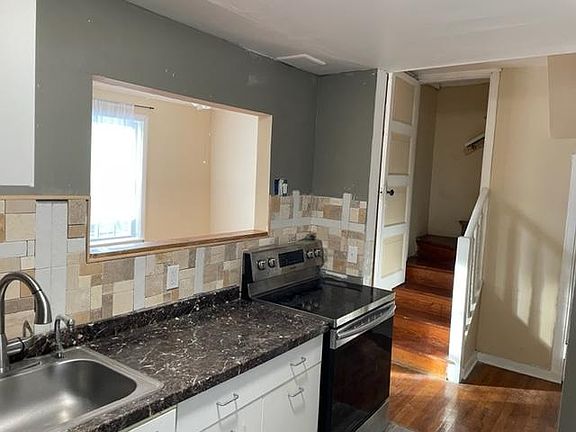 Kitchen with view of stairs to loft