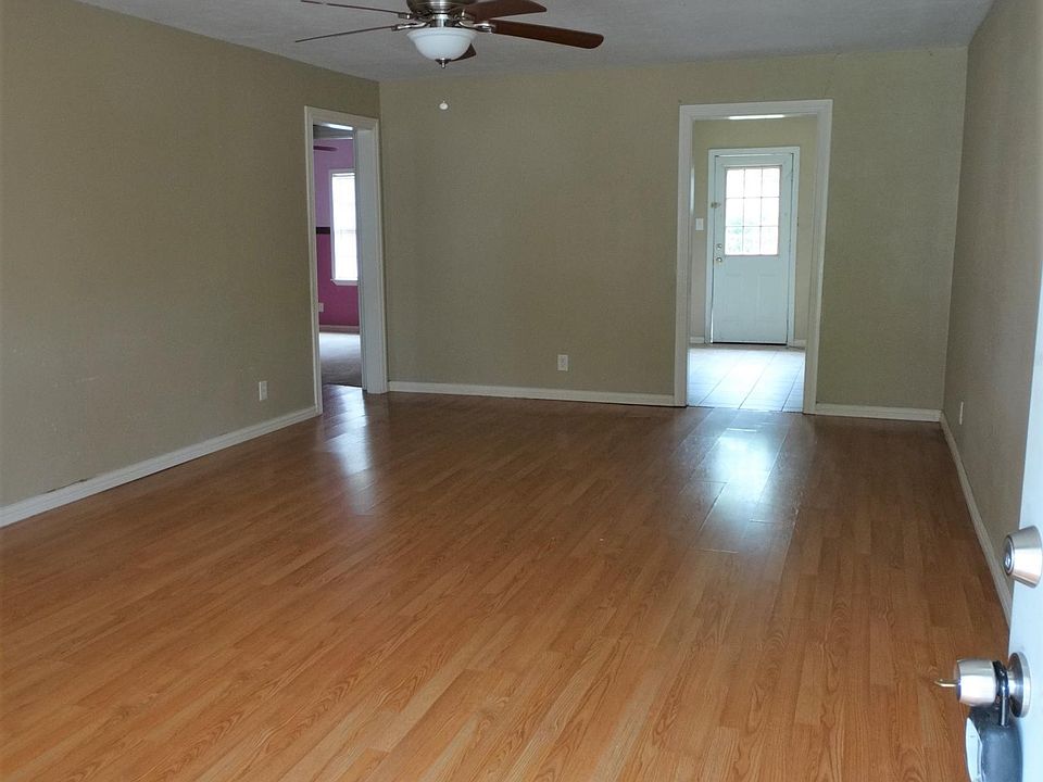 Huge living room with ceiling fan, Laminate floors, front do