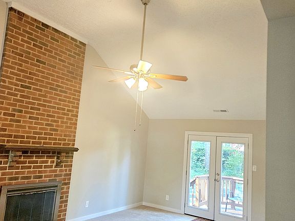 Spacious living room with vaulted ceilings. French doors open to the back deck.