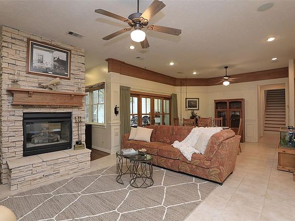 Stone 2 sided fireplace is accent piece for family and study/sun room