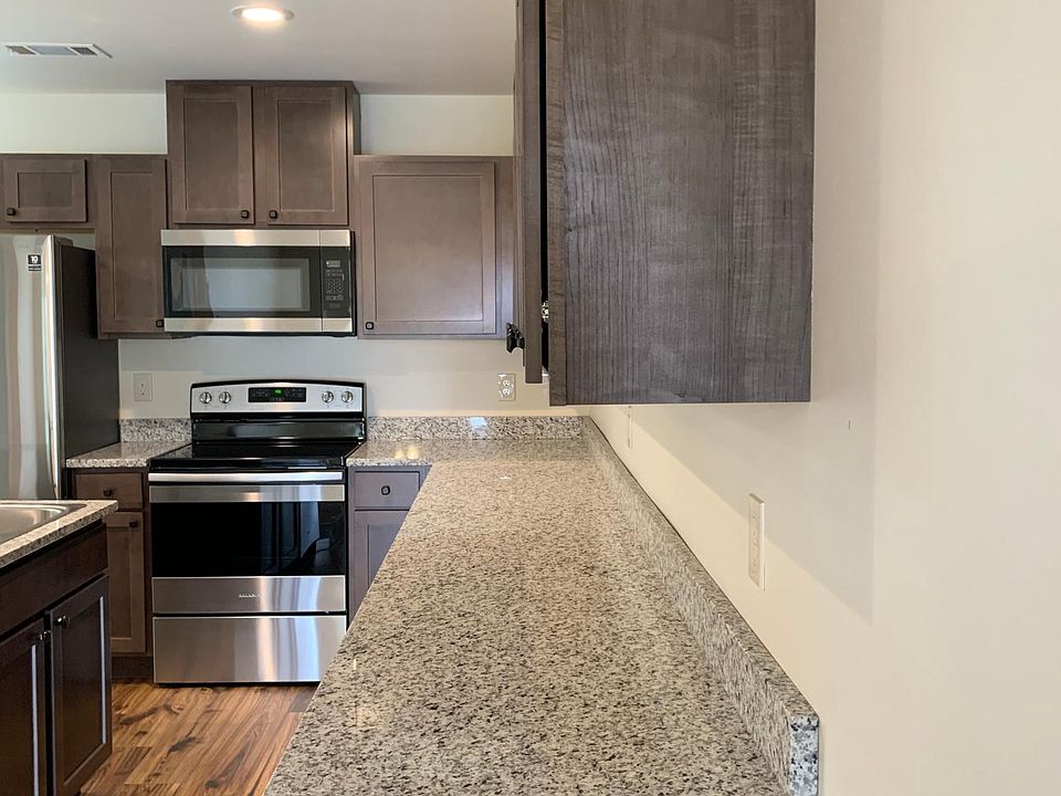 Granite counter tops throughout the kitchen with room for barstools at the island. Lots and lots of cabinets and counter space.