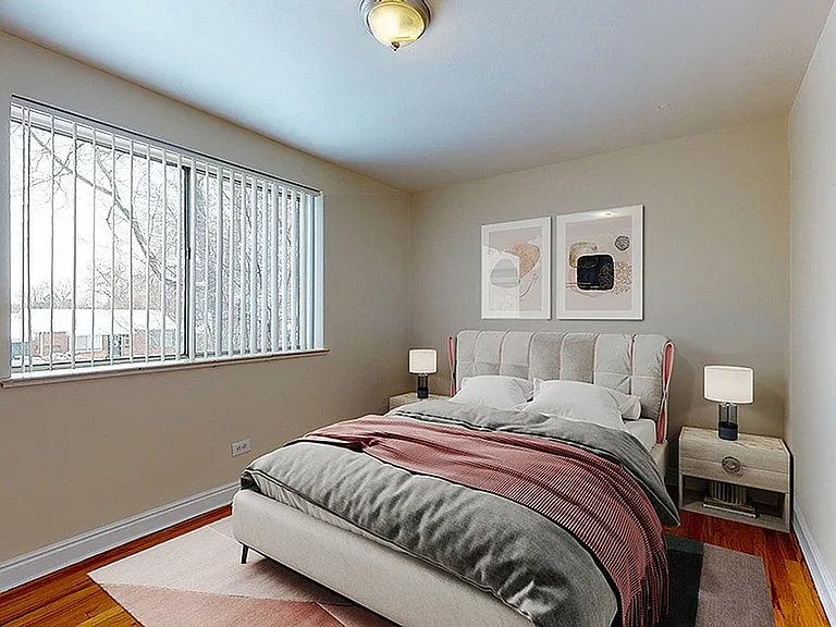 Inviting bedroom with modern decor, cozy natural lighting, and elegant artwork, perfect for relaxation.