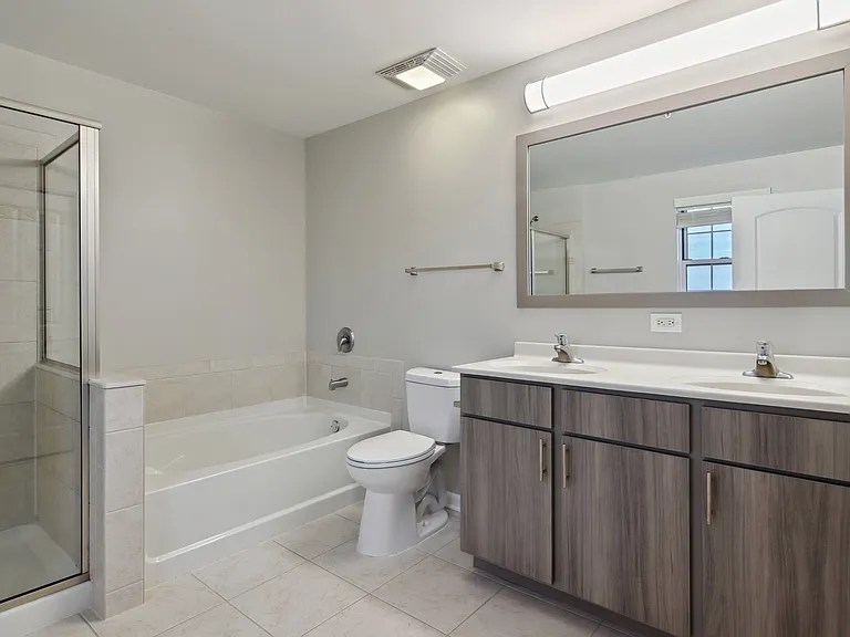 Modern bathroom with double vanity and soaking tub