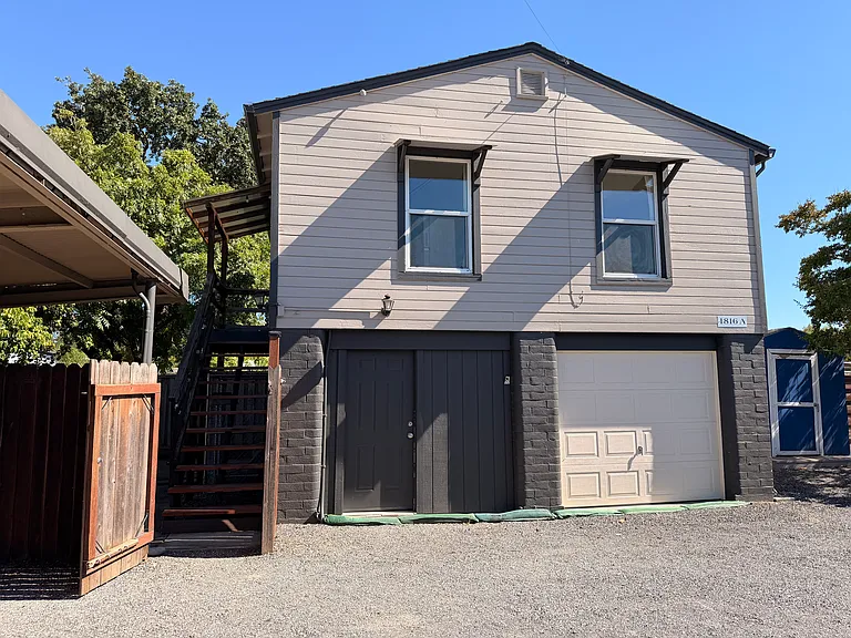 Apartment upstairs, storage/laundry downstairs on left side of building, covered parking on the far left, out of the range of the photo