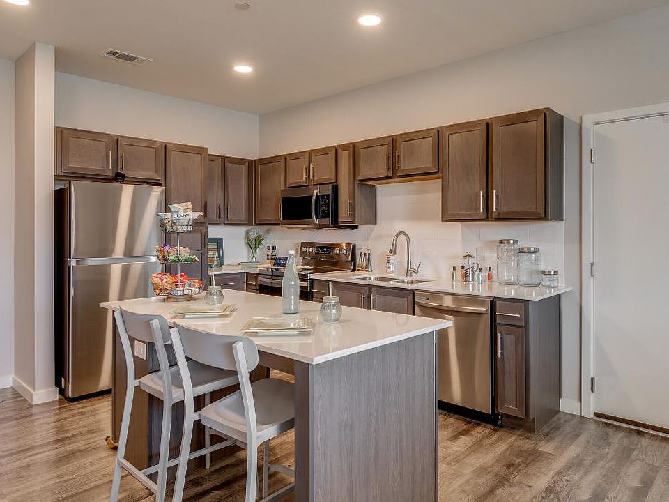 Kitchen with island, quartz countertops, and Stainless steel appliances