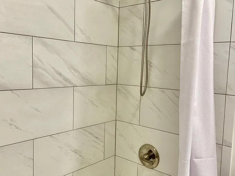 New porcelain tile tub surround and tub