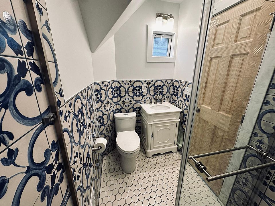 Newly renovated bathroom, walk in shower with rain shower head, handheld shower head, glass sliding door. Water saving toilet, beautiful marble vanity, spanish wall tile
