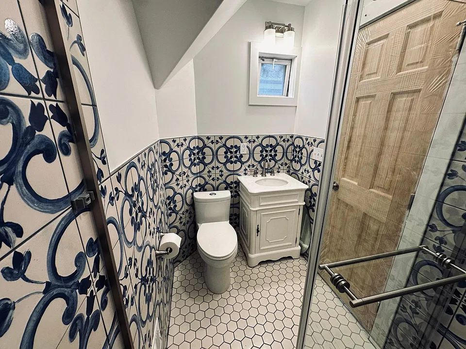 Newly renovated bathroom, walk in shower with rain shower head, handheld shower head, glass sliding door. Water saving toilet, beautiful marble vanity, spanish wall tile