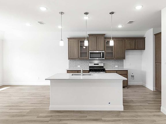 Prosper floor plan showcasing open-concept single-story living with a dining area, covered patio, an