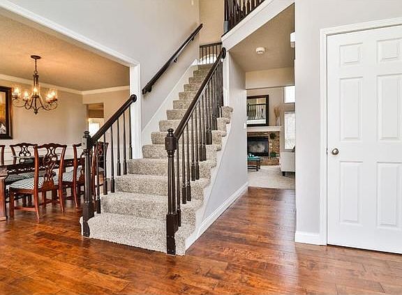 Beautiful hand scraped hardwood flows from the entry through the Dining Room to the Kitchen and Breakfast Room beyond.  The stairs lead to a balcony loft overlooking the Entry and leading to the gallery overlook.  The stair system and rails have been fini