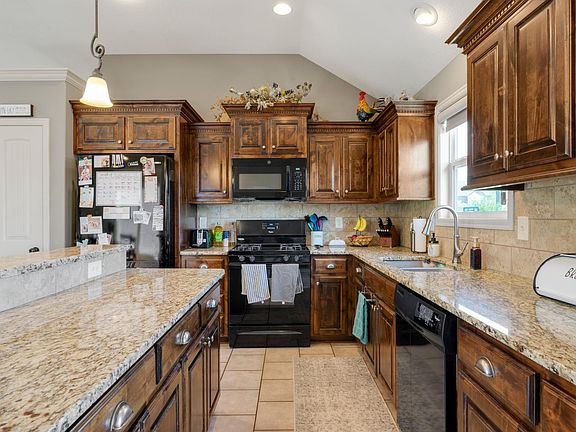 Kitchen with updated appliances and gas range.