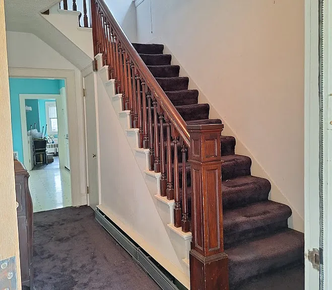 hallway from front door leads into kitchen or upstairs to bedrooms