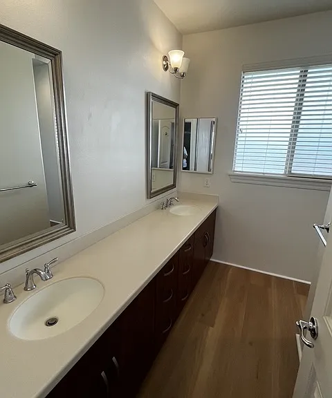 Primary bathroom with dual sinks and walk in shower