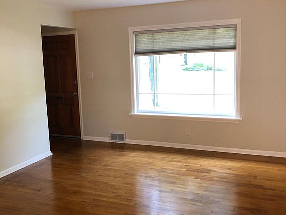 view of bay window and front door from the sizable living room