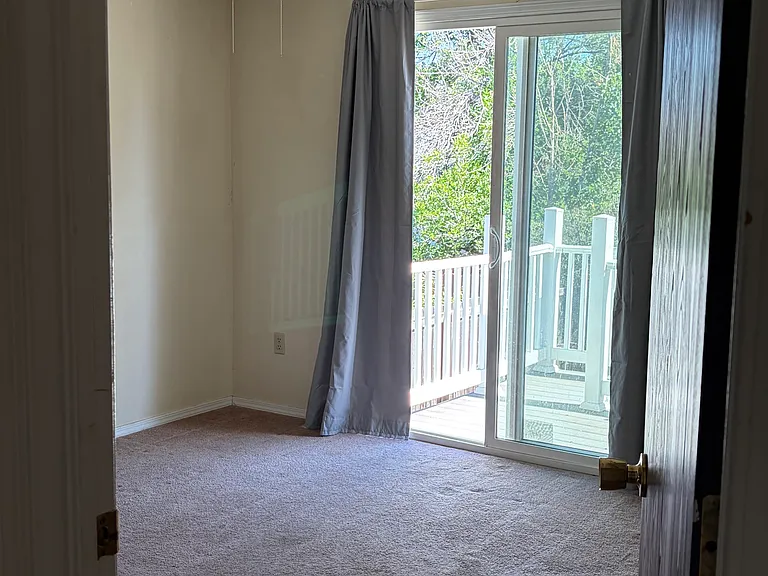 Upstairs Bedroom 1 with view of Sliding Door to Upstairs Deck