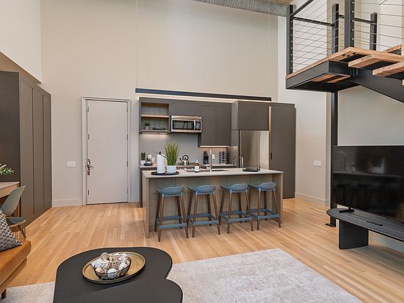 Open concept kitchen with seating for 4 at the kitchen island. The kitchen is fully stocked and ready to use.