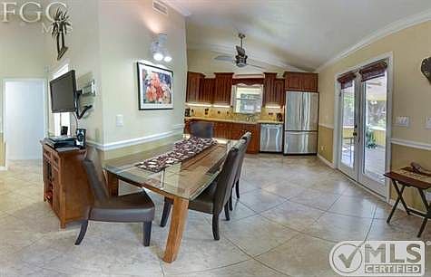glass dining table connects living room and kitchen