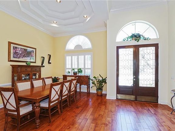 Formal Dining Room with Tray Ceiling and Foyer with Leaded Glass Doors