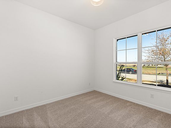 Your secondary bedroom features plush carpet, fresh paint, closet, and a large window that lets in p