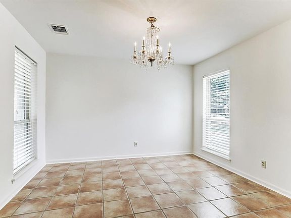 Dining Room with tile floor mirroring the formal living room.