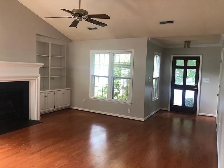 Living room with built ins and fireplace.
Beautiful engineered hardwoods 
Lots of light
Blinds on windows for privacy