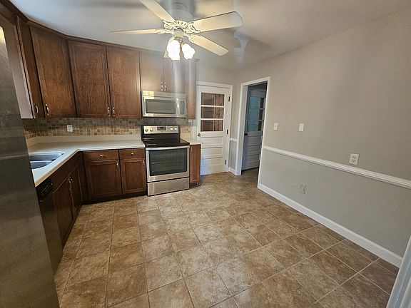 Updated kitchen with chair railing, SS appliances and tile floors.