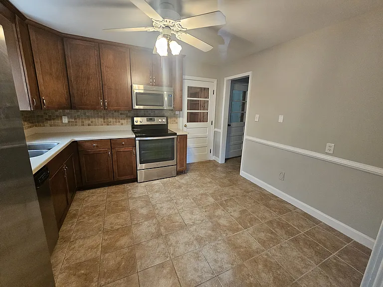 Updated kitchen with chair railing, SS appliances and tile floors.