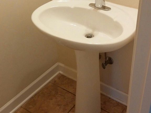 Half bath downstairs with ceramic tile flooring