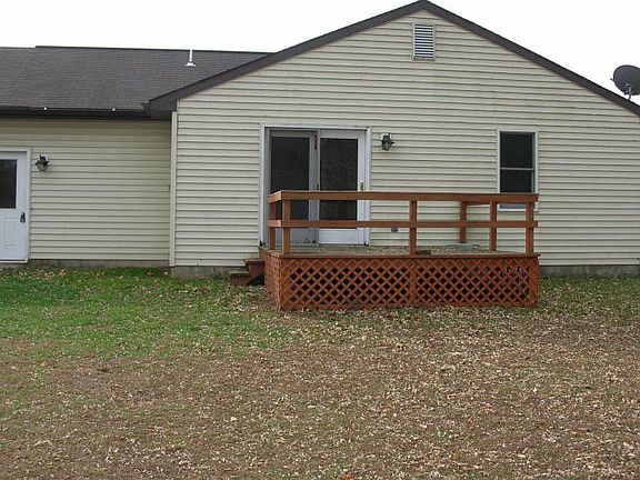 REAR VIEW WITH DECK AND WALK IN ACCESS TO GARAGE