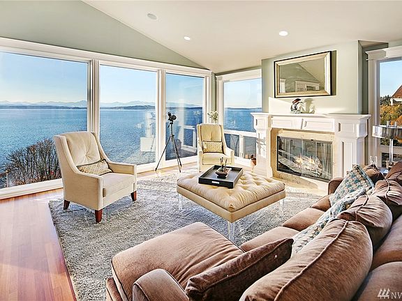 Spacious Living Room with gas fireplace and spectacular Sound, mountain and sunset views.