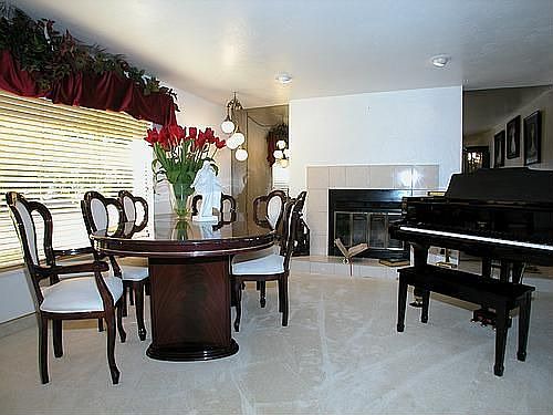 Living room features a cozy fireplace and a large picture window.