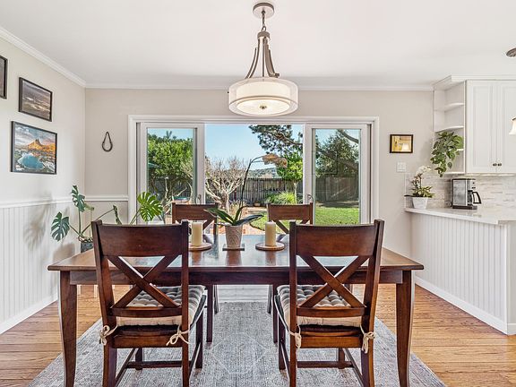 Dining space with oversized slider splilling out to the abundant yard spaces.
