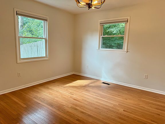 Primary bedroom with fresh paint and hardwood flooring