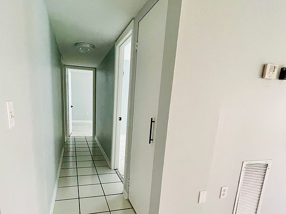 Hallway to bedrooms & bathrooms. Hall pantry door closed.