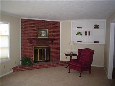 THE FOYER OPENS TO A LARGE LIVING ROOM WITH FULL BAY WINDOW AND WINDOW SEAT.