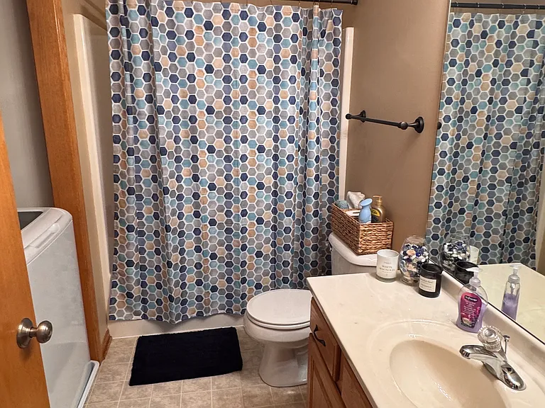 Bathroom outside upstairs bedroom, includes laundry